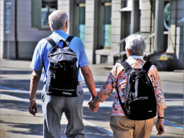 Senior couple walking and smiling outdoors